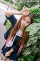 A woman in a school uniform posing for a picture.