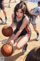 A girl in a basketball uniform crouching down with a basketball.