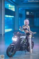 A woman in a bikini sitting on a motorcycle.